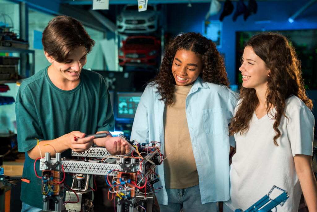 Group of young people doing experiments in robotics in a laboratory